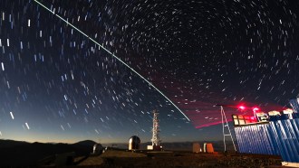 a test of a quantum communications satellite. Various towers and lights are shown against a backdrop of a time-lapsed night sky