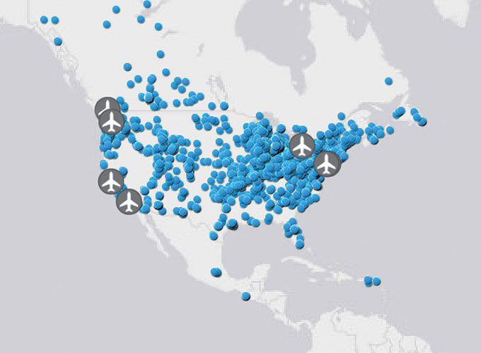 A map of North America showing hundreds of blue dots and six gray dots with airplanes to mark wastewater sites.