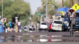 Person riding a bicycle in Phoenix during a period of extreme heat.