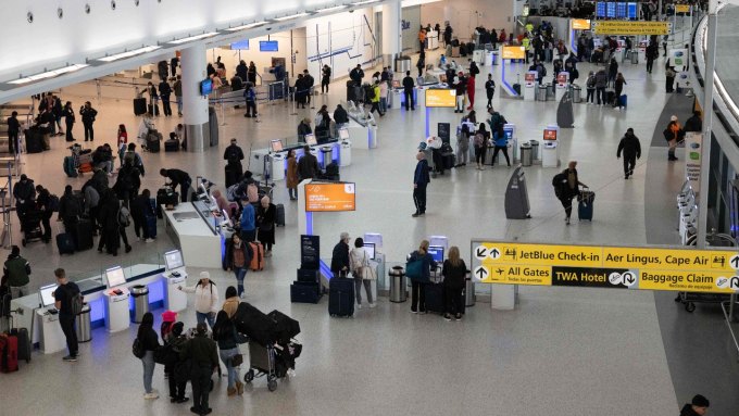 A photo shows travelers arriving at JFK airport in New York City.